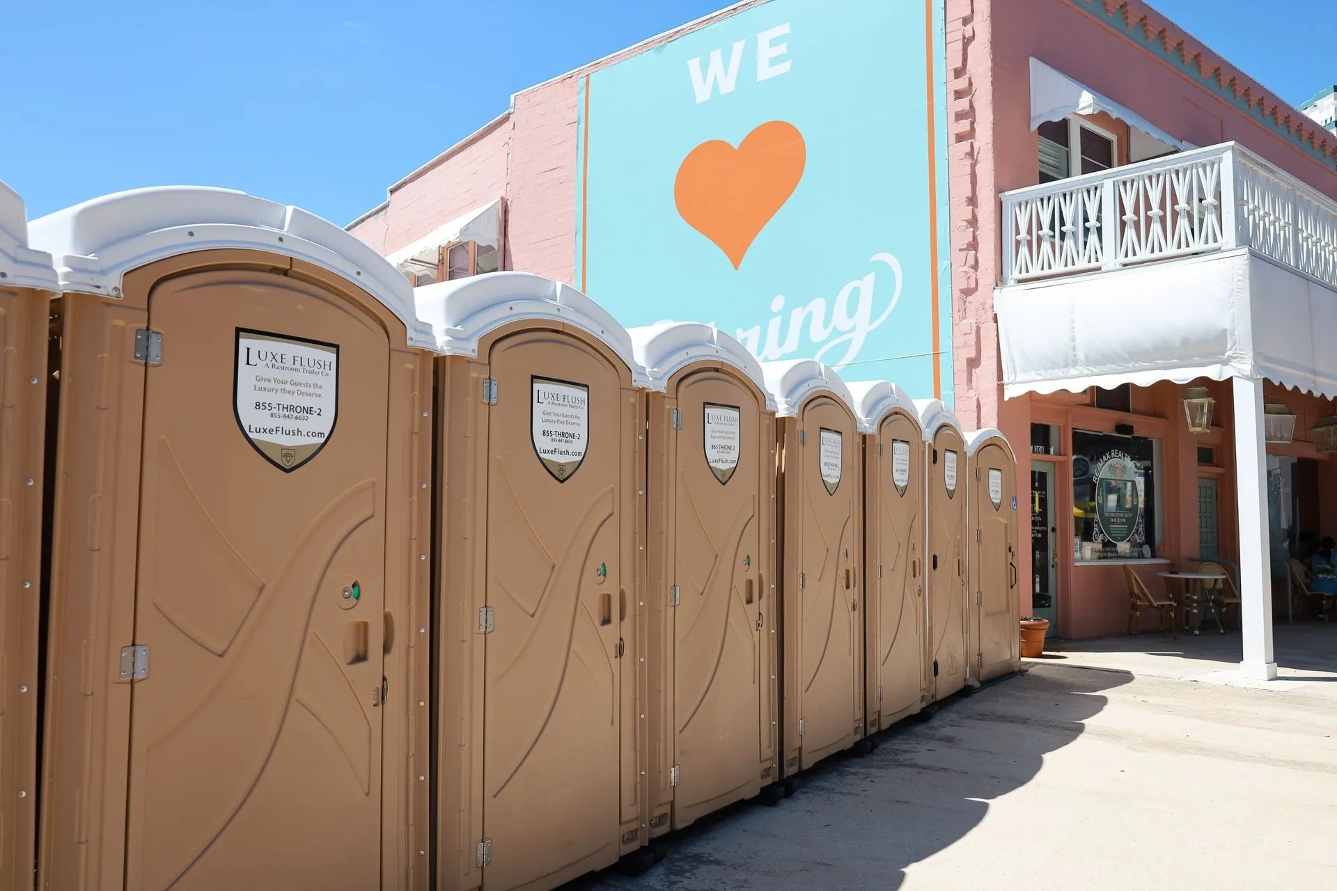 Row of Luxe Flush porta potties at an outdoor event